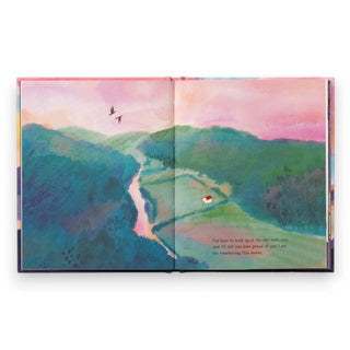 Open book with a colorful landscape illustration on a white background