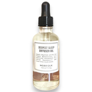 A clear glass bottle with a black dropper, labeled 'Deepest Sleep Diffuser Oil' with white and black text, against a white background.