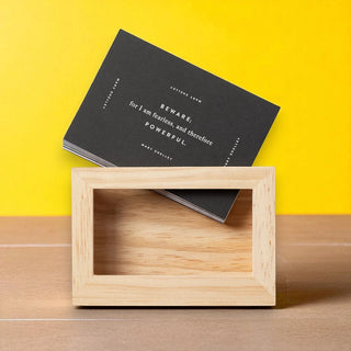Wooden picture frame with black cards with an inspirational quote on a yellow background