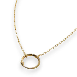 Gold necklace with a circular snake pendant on a white background