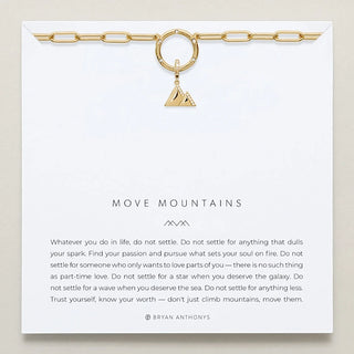 Gold necklace with a triangle pendant on a white card with text