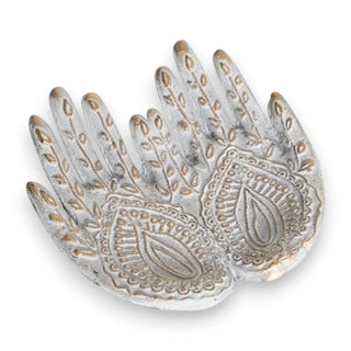 Decorative ceramic hand-shaped dish with intricate designs on a white background
