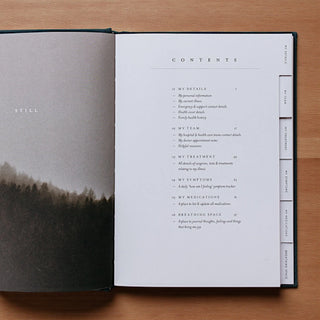 Open book with a contents page on a wooden surface