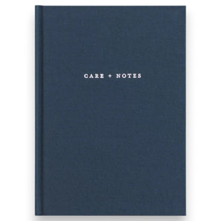 Blue notebook with 'Care + Notes' text on a white background