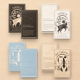 Set of zodiac-themed cards on a wooden surface