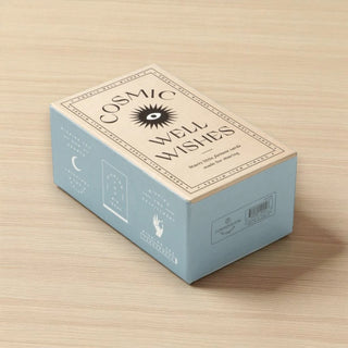 Box labeled 'Cosmic Well Wishes' on a wooden surface