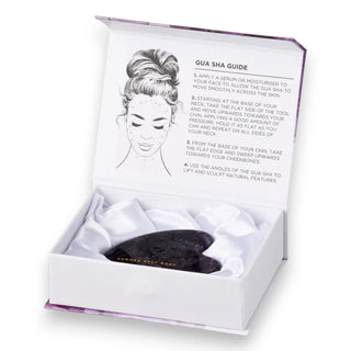 Gua sha tool in a white box with instructions on a white background