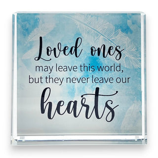 Decorative plaque with inspirational quote: Loved ones may leave this world but never leave our hearts, on a light blue background