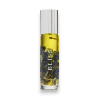 Roll-on bottle with with essential oils, blue sodalite chips and 24k gold flakes and visible text on a white background
