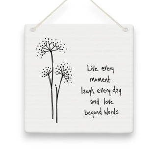 Decorative wall hanging with black floral illustrations and motivational quote on a white background