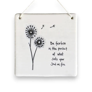 Decorative wall art with dandelion illustrations and a motivational quote on a white background.