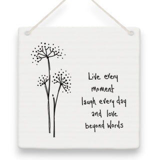 Decorative wall art with black floral illustrations and motivational quote on a white background