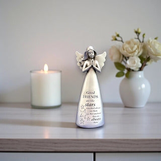 A silver resin angel statue with wings and hands in a prayer position with the inscription Good friends are like stars, you don't always see them but you know they are always there.