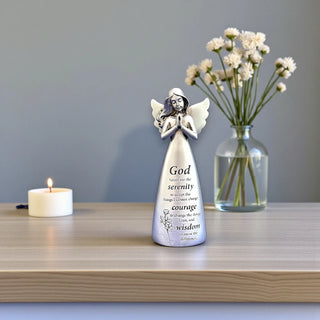 A silver resin angel with wings and hands in a prayer position with the inscription God grant me the serenity to accept the things I cannot change, courage to change the things I can, and wisdom to know the difference.