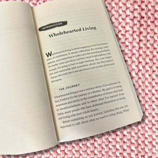Open book with text on a pink knitted surface