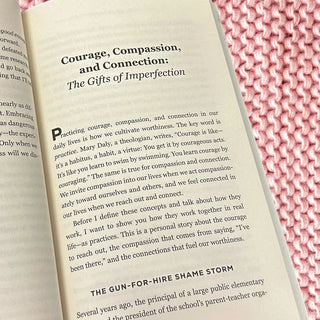 Open book with text on a pink knitted fabric background