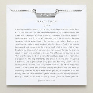 Necklace with 'Gratitude' pendant on a card with text