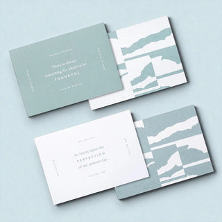 Four cards with uplifting quotes on a light blue background