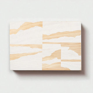 Wooden block with white abstract patterns on a light gray background