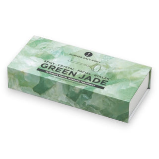 Green jade facial roller packaging on a white background