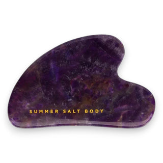 Purple gua sha crystal tool with 'Summer Salt Body' branding on a white background