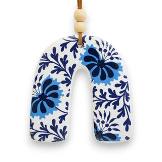 Decorative hanging rainbow-shaped with blue floral patterns on a white background