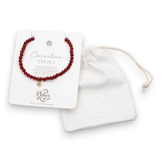 Carnelian energy bracelet on a display card with a white drawstring bag on a white background