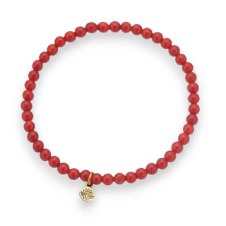 Red carnelian beaded bracelet with a gold lotus charm on a white background