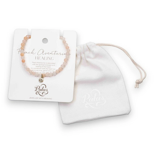 Peach aventurine bracelet on a card with a white drawstring bag on a white background