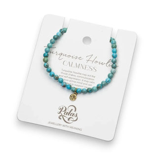 Turquoise Howlite beaded bracelet with a gold lotus charm on a Palas branded card.