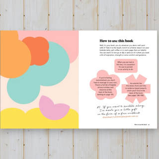 Book with colorful abstract design on a wooden surface