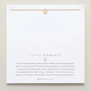 Necklace with a gold chain and teardrop charm on a 'Little Moments' card with a quote by Bryan Anthony.