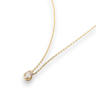 Gold necklace with a teardrop-shaped pendant on a white background