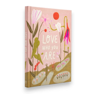 Book with floral design and 'Love Who You Are' text on a pink background