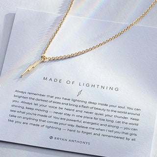 Gold necklace with a lightning bolt pendant on a card with text 'Made of Lightning' by Bryan Anthonys
