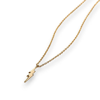 Gold necklace with a lightning bolt pendant on a white background