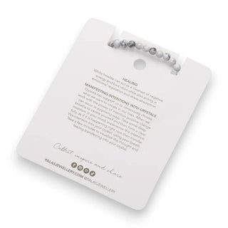 Bracelet on a card with text and brand information, on a white background