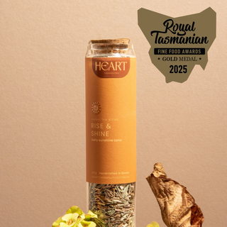 Tea packaging with 'Heart Therapeutics' branding and 'Royal Tasmanian Fine Food Awards 2025' gold medal badge on a beige background.
