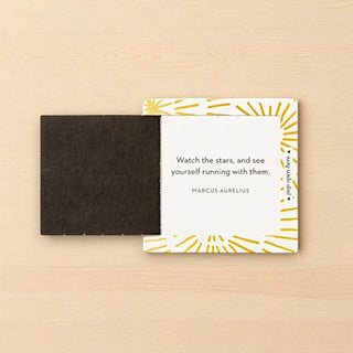 Pop open note card with motivational quote on a wooden surface