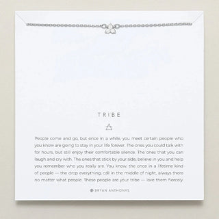 Silver necklace on a card with text and brand name