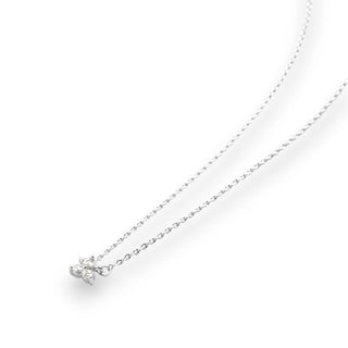 Silver necklace with a small pendant with 3 gemstones in a triangular shape on a white background