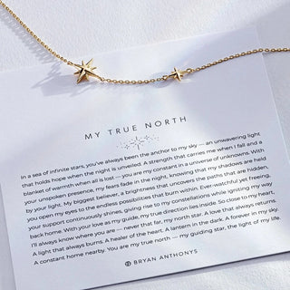 Gold necklace with star pendants on a card with text 'My True North' by Bryan Anthonys.